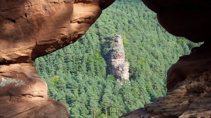 Blick über ein Loch im Feld auf den Glasfelsen im Pfälzerwald. | © DAV/Markus Maier